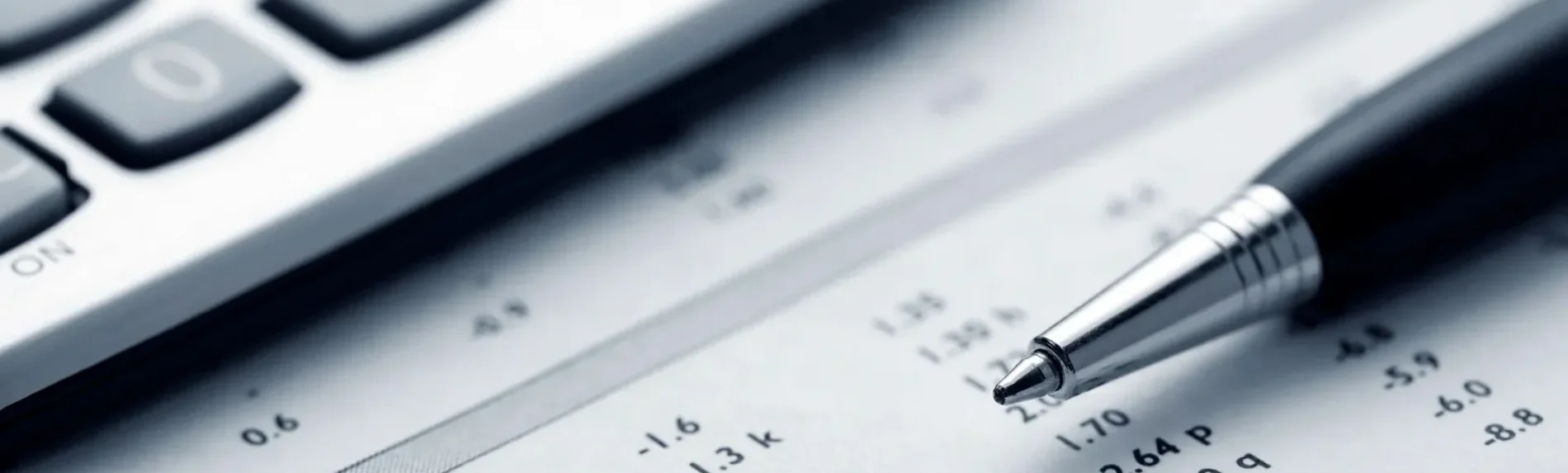 A calculator and pen on top of some paper