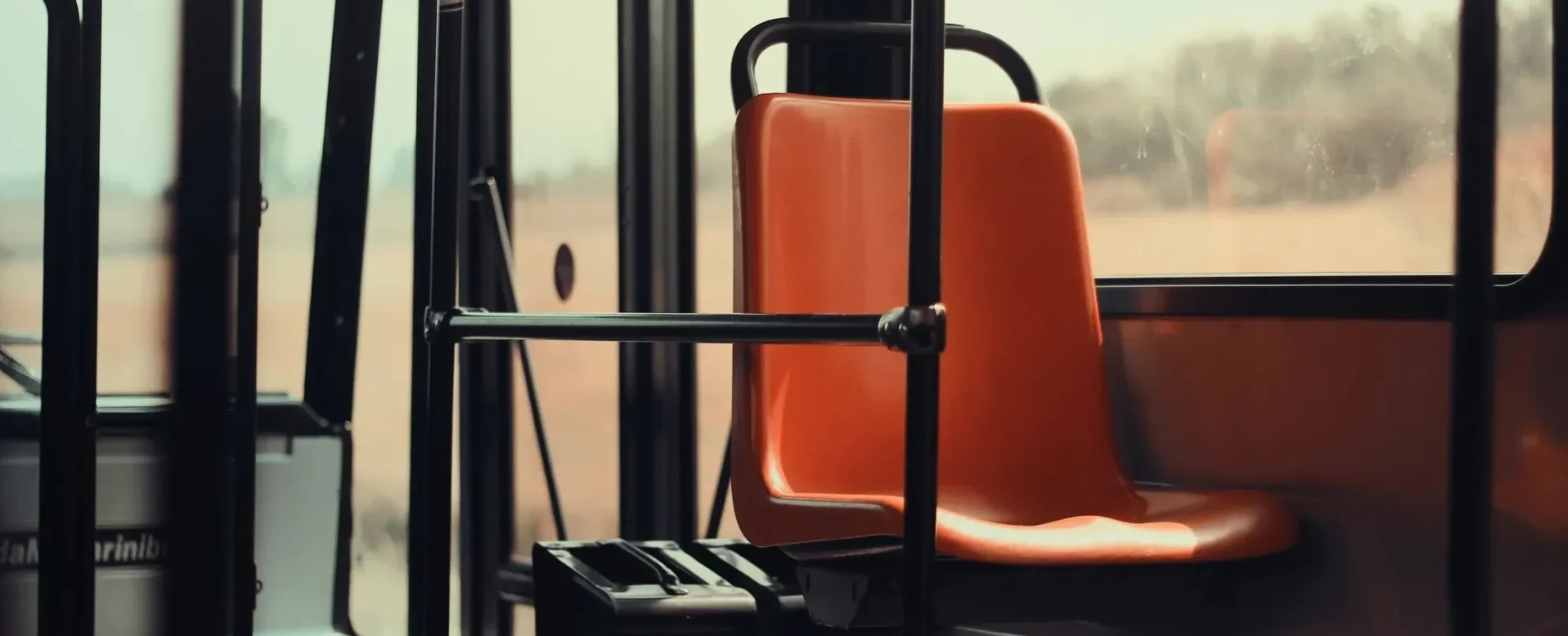 qtq80-rkVLzm A bus seat with the arm rest folded up.