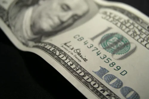 A close up of the face on a one dollar bill