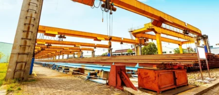 A large crane is in the middle of an industrial area.