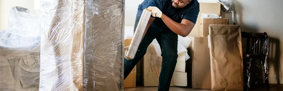 A man is moving furniture in the house