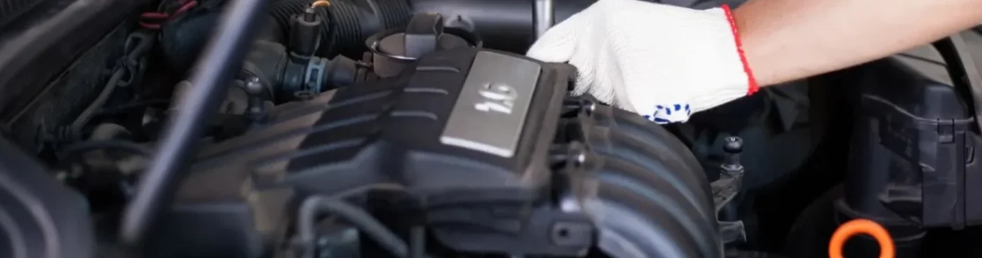 A person working on the engine of a car.