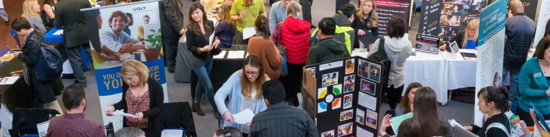 A crowd of people standing around at an event.