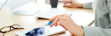 A person is using their tablet at the table