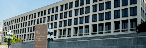 A building with many windows and a large wall.