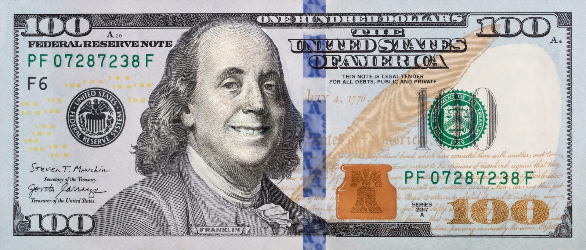 A close up of the face on a one hundred dollar bill