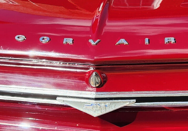 A close up of the hood and trunk of an old car.