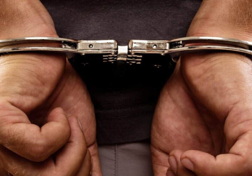 Close-up. Arrested man handcuffed hands at the back