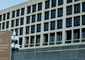 A building with many windows and a large wall.