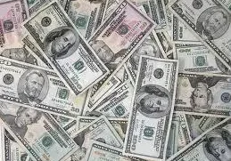 A pile of money that is laying on the ground.