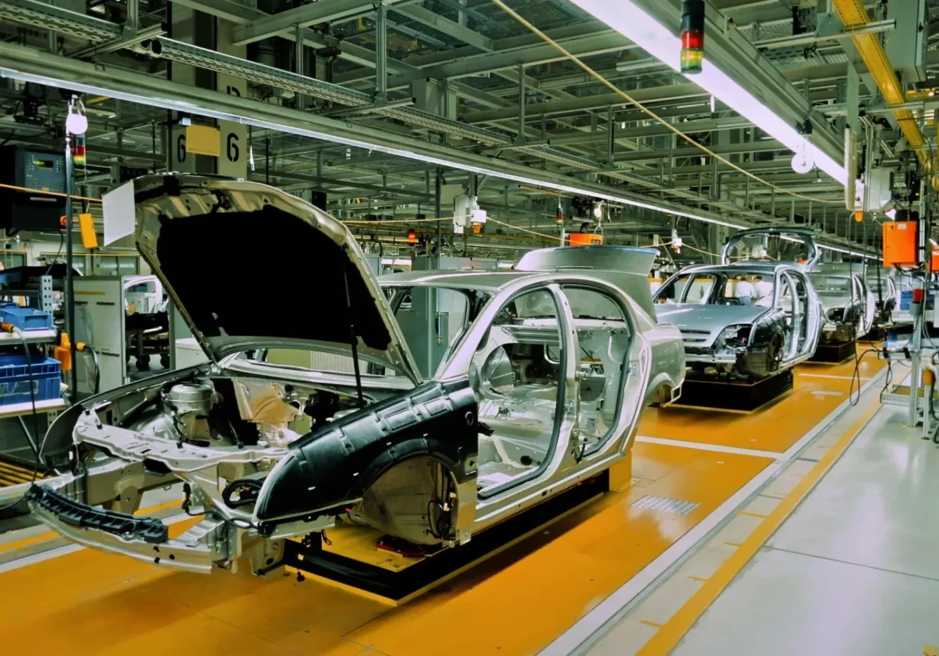 A car assembly line with cars in the process of being built.