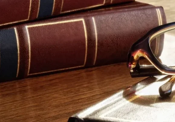 A book and glasses on the table