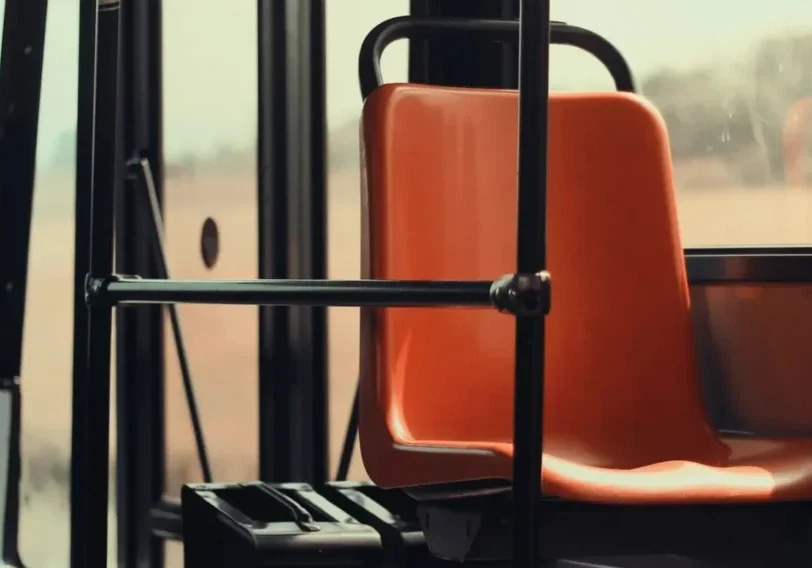 qtq80-rkVLzm A bus seat with the arm rest folded up.