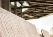 A row of benches on the side of a walkway.