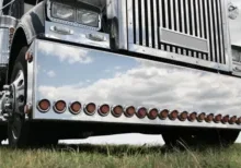 A close up of the front end of a semi truck