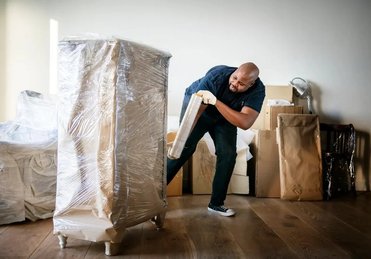 A man is moving furniture in the house