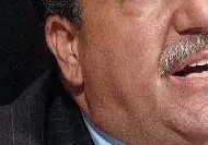 A man with a beard and mustache wearing a suit